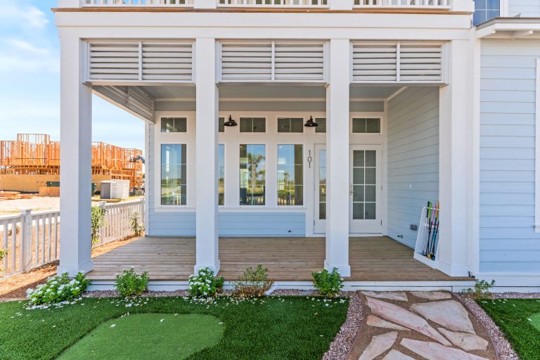 Covered porch with a backyard putting green at 101 Sea Whip Lane