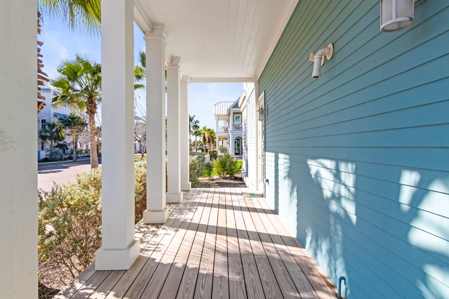 Wraparound porch along the aqua siding at 152 Sea Rocket Lane