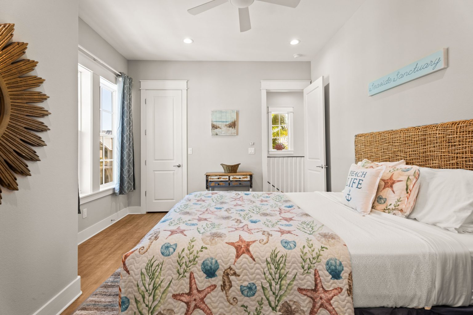 Bedroom with a starfish quilt and woven headboard at 200 Sunset Avenue