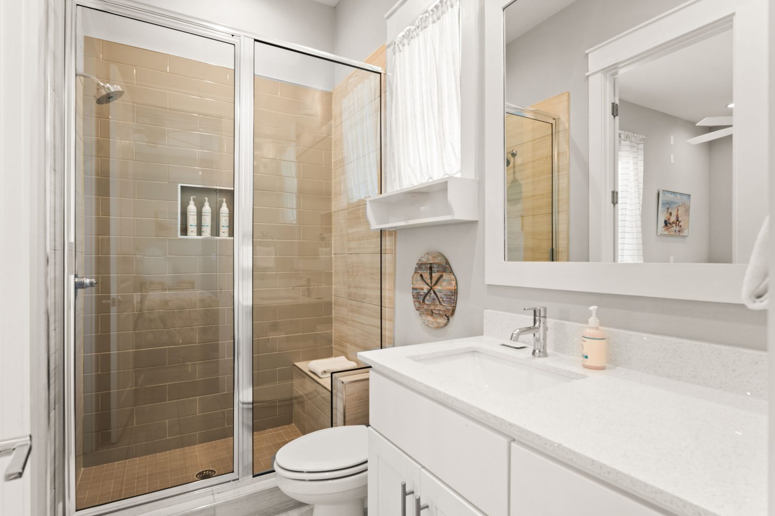 Bathroom with a tiled walk-in shower and white vanity at 200 Sunset Avenue