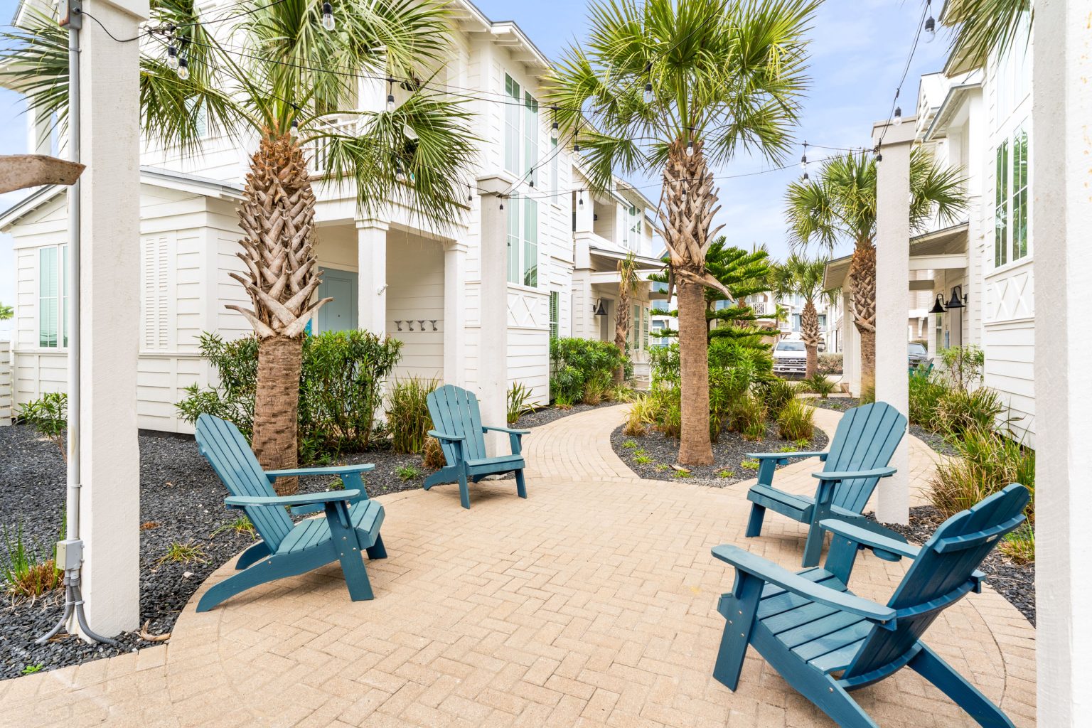 Shared courtyard with blue Adirondack chairs near 214 Sunset Avenue