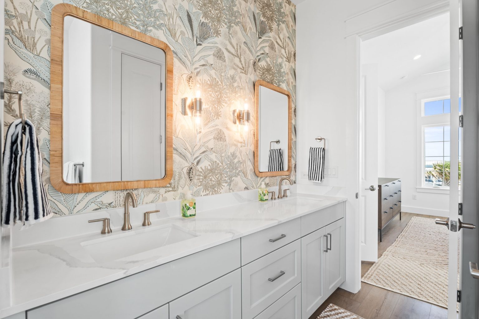 Bathroom with a double vanity and botanical wallpaper at 205 Horse Tail Lane