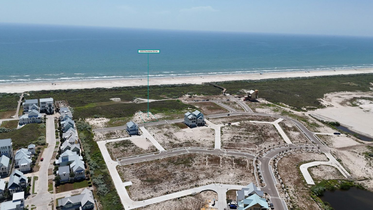 Aerial view marking the 333 Purslane Drive homesite beside the dunes and Gulf