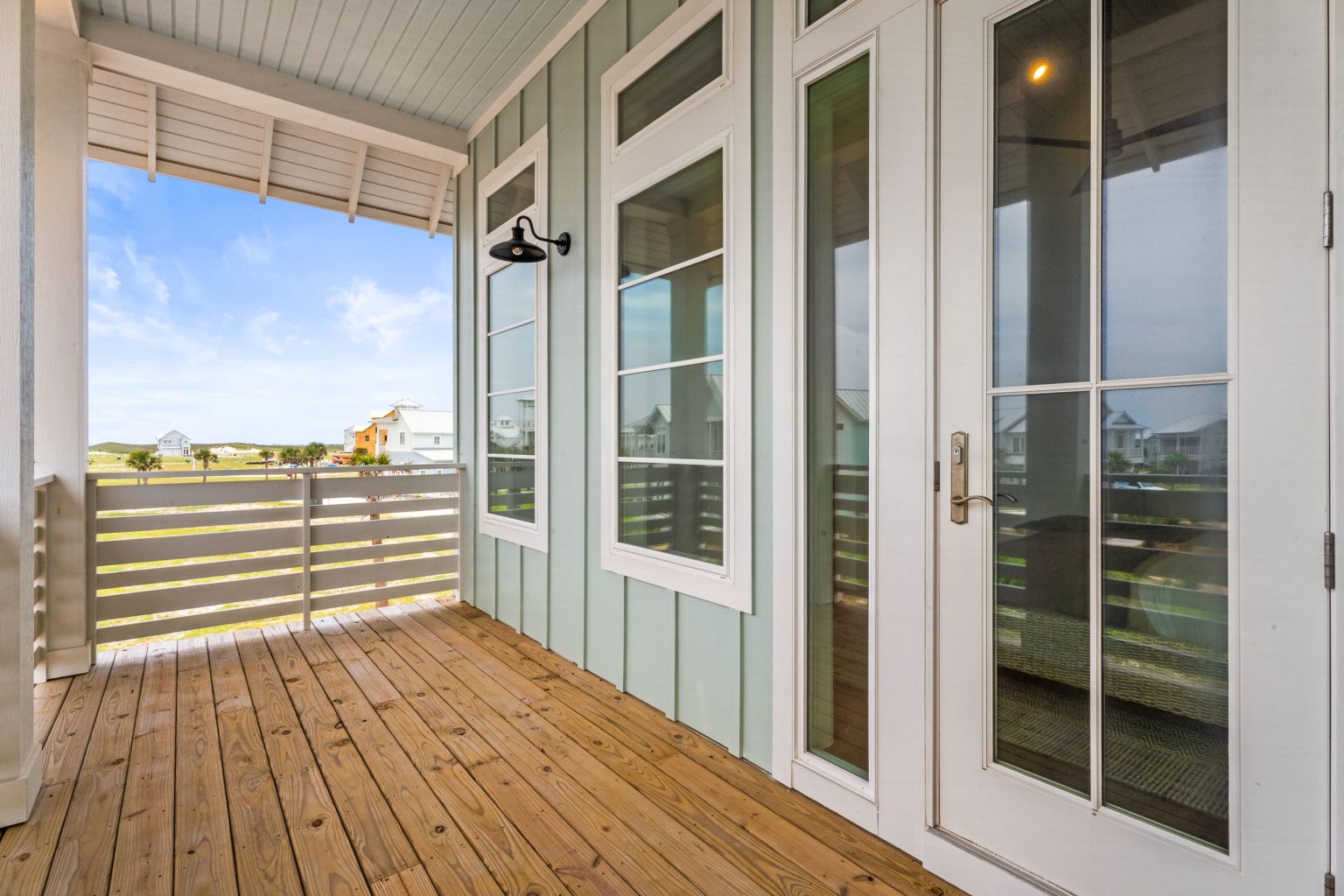 Covered upper porch with French doors at 120 Lotus Lane