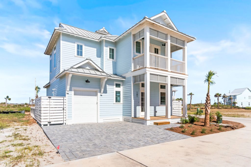 Exterior with an attached garage and paver driveway at 101 Sea Whip Lane