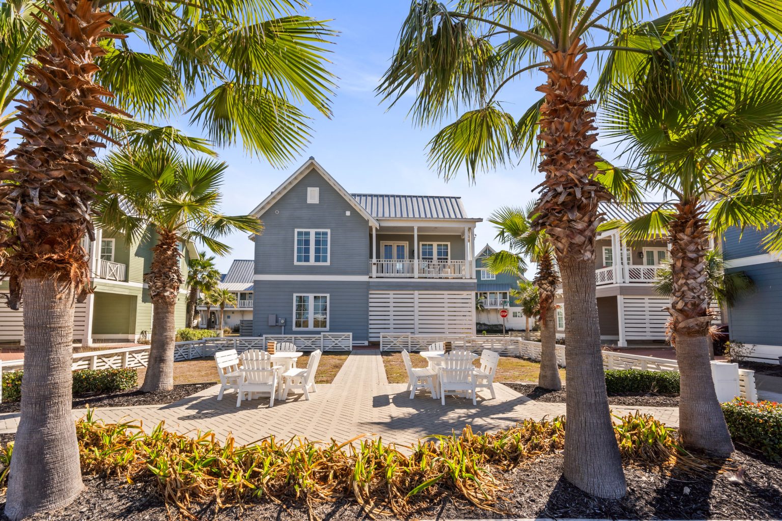 Shared courtyard with patio seating and palms near 200 Sunset Avenue
