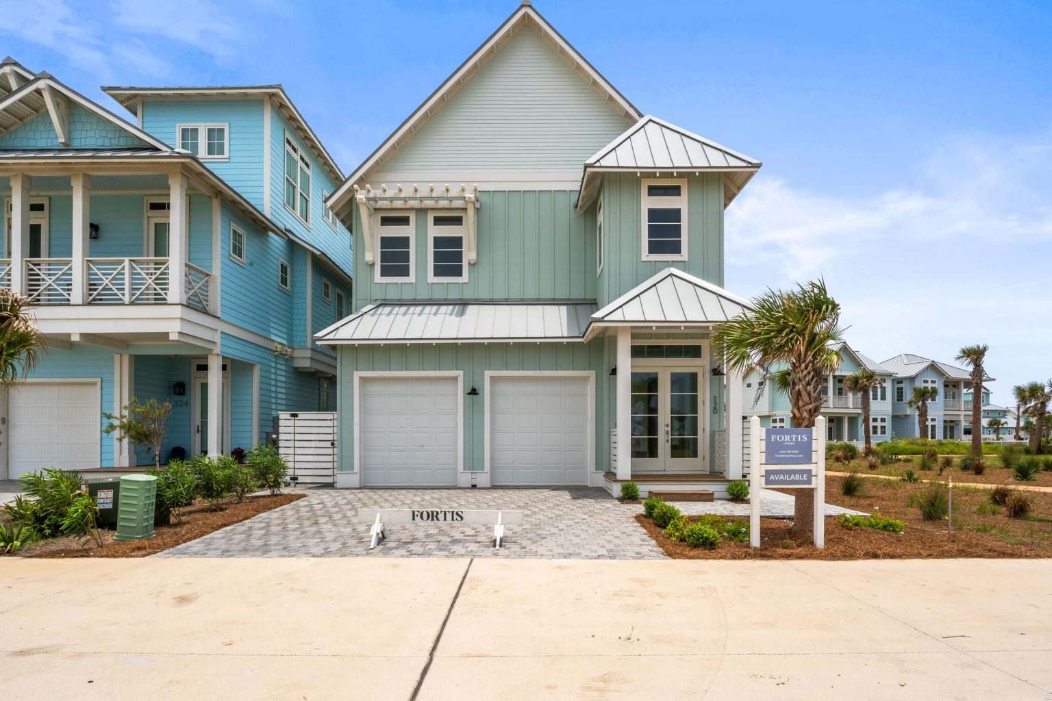 Front of 120 Lotus Lane with a two-car garage and paver driveway