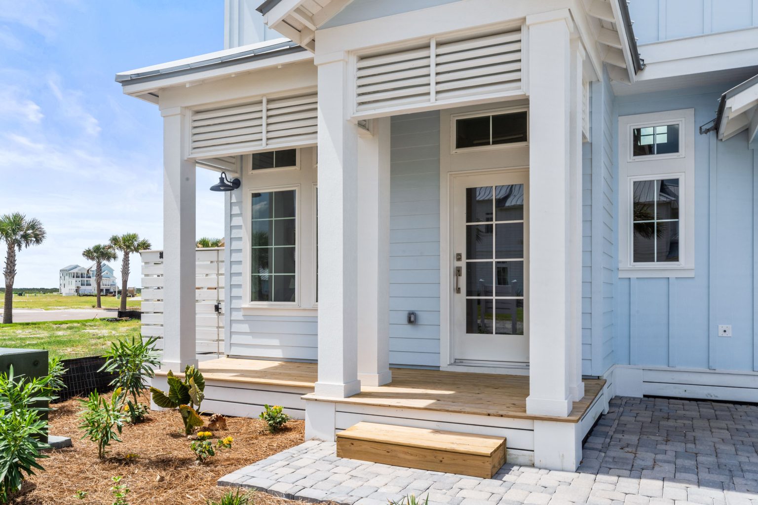 Covered front entry with a paver walkway at 205 Horse Tail Lane