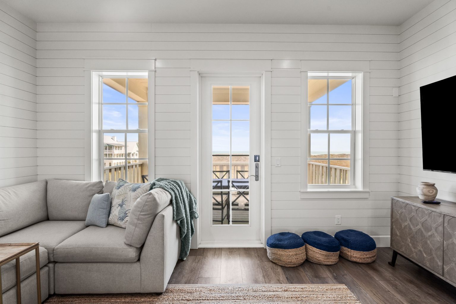 Living room with sectional, TV and French doors at 250 Sunrise Avenue