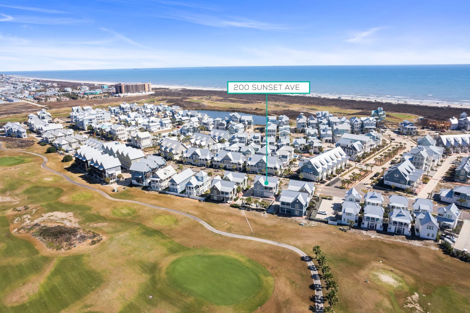 Aerial view marking 200 Sunset Avenue between the golf course and the beach
