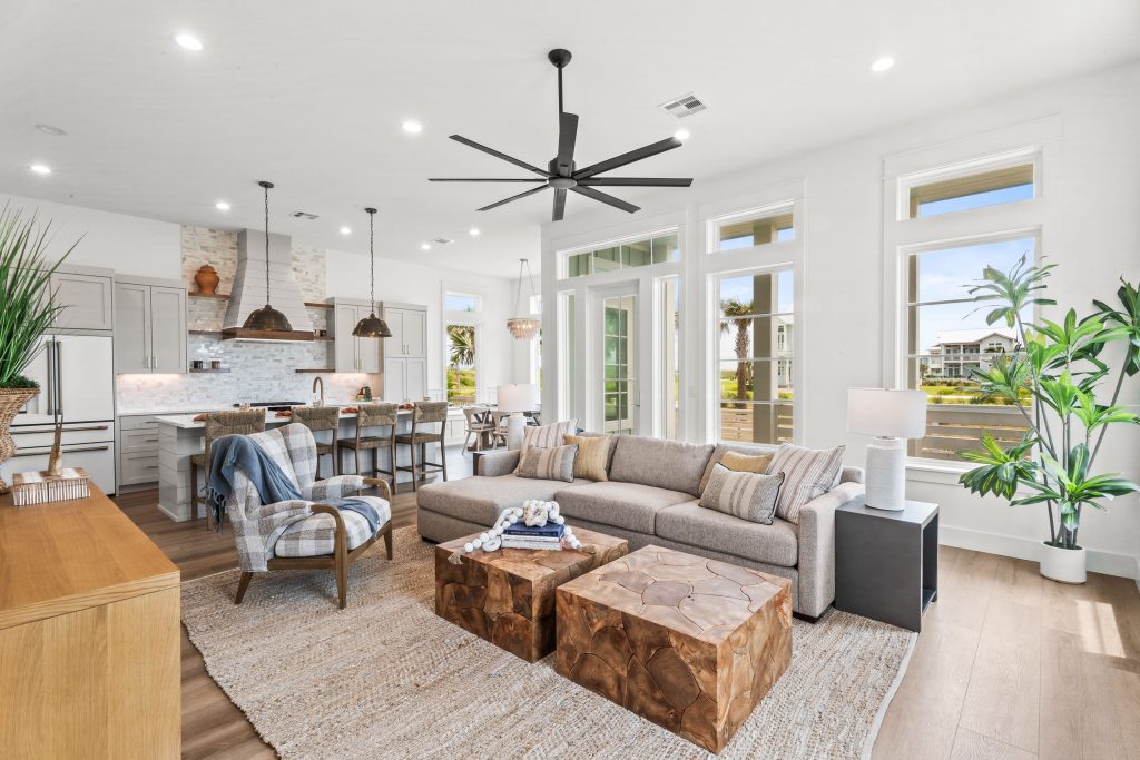 Living room with a sectional sofa, open to the kitchen and dining area at 120 Lotus Lane