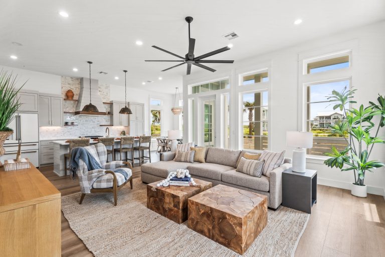 Living room with a sectional sofa, open to the kitchen and dining area at 120 Lotus Lane