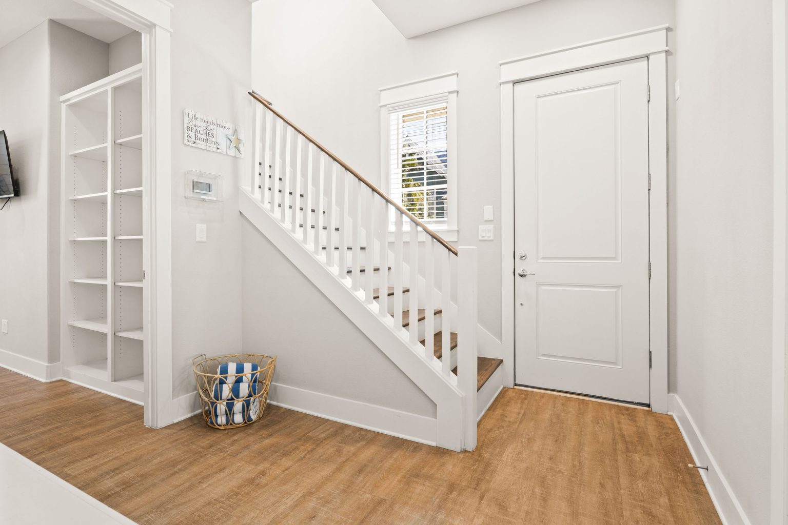 Entry hall with staircase and built-in shelves at 200 Sunset Avenue