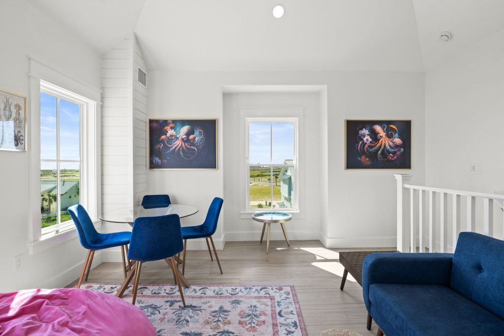 Bonus room with a blue sofa and dining table at 724 Sunset Avenue