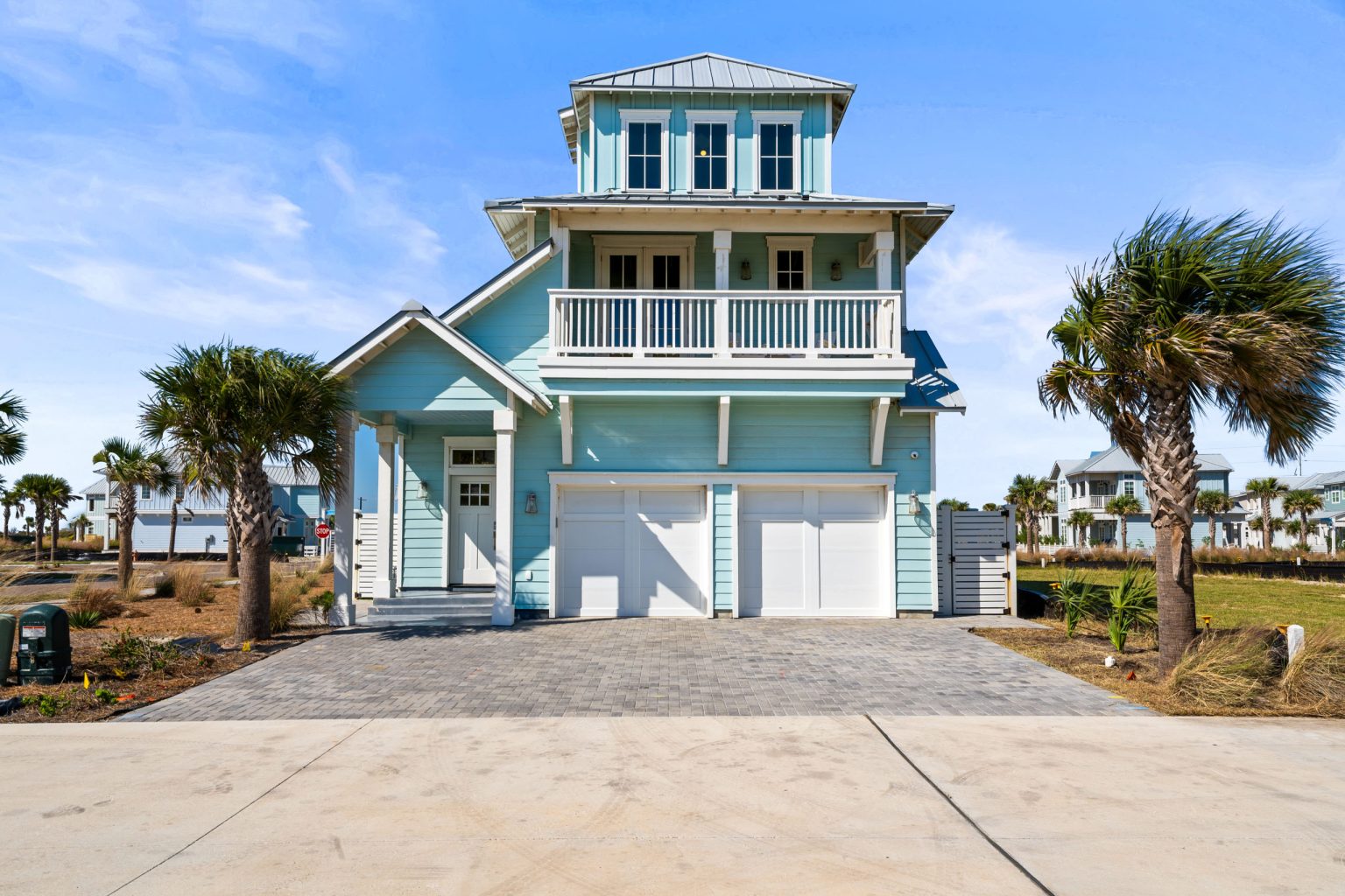 Front of 724 Sunset Avenue with a two-car garage and palms