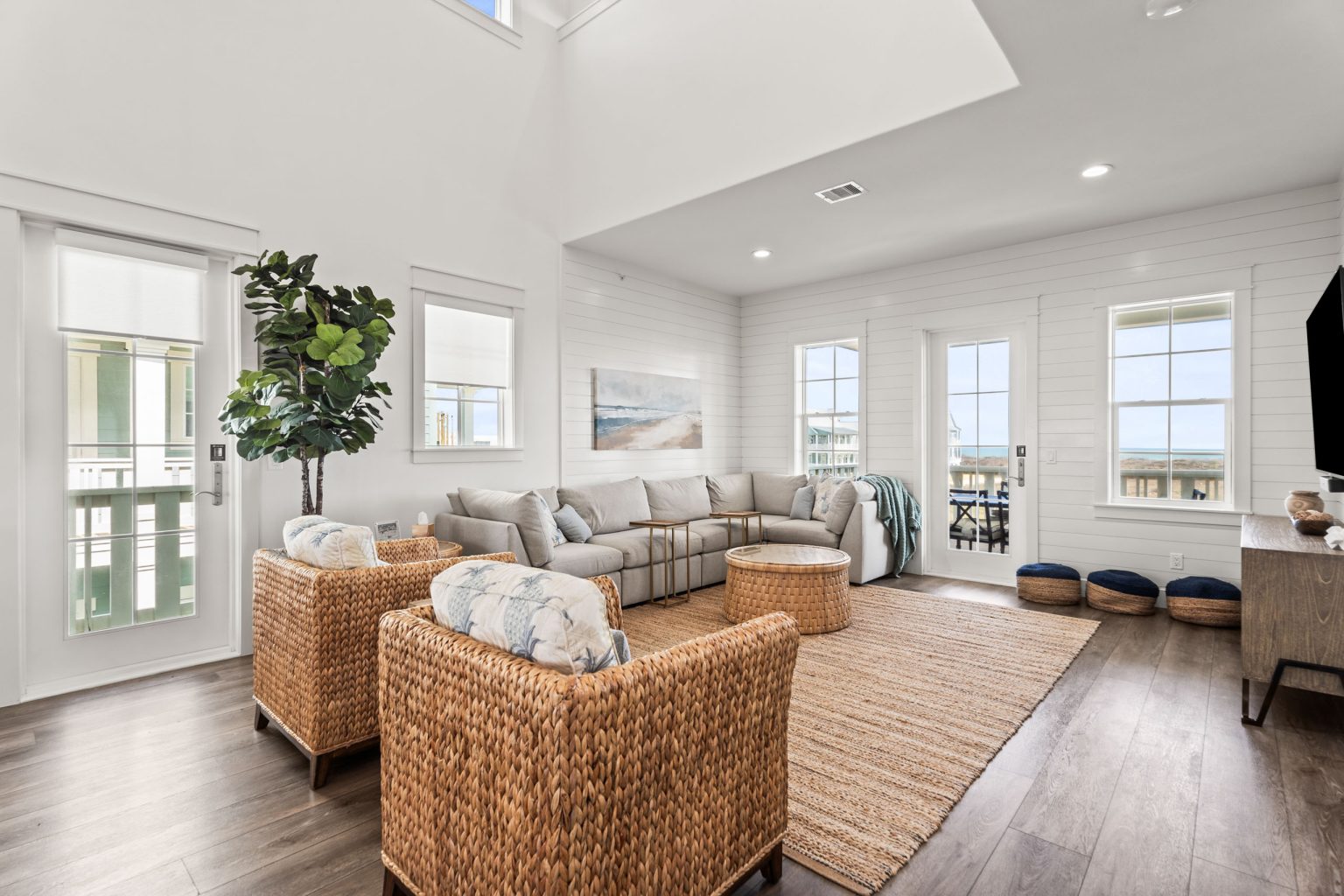 Living room with wicker armchairs and porch doors at 250 Sunrise Avenue