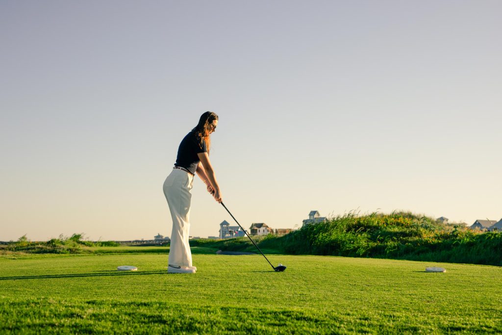 A golfer teeing off on the Palmilla Beach course
