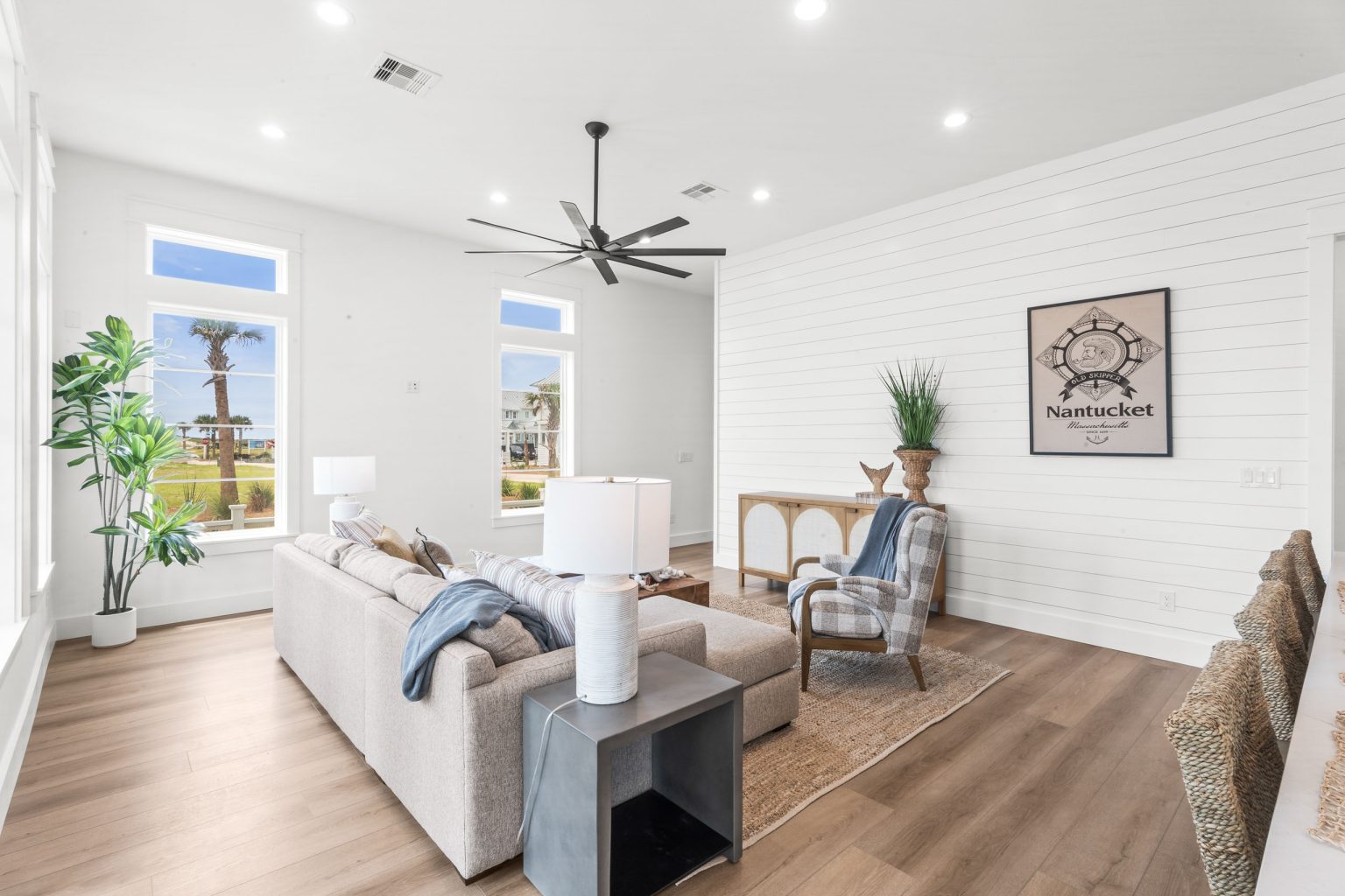 Living room with shiplap wall and large windows at 120 Lotus Lane