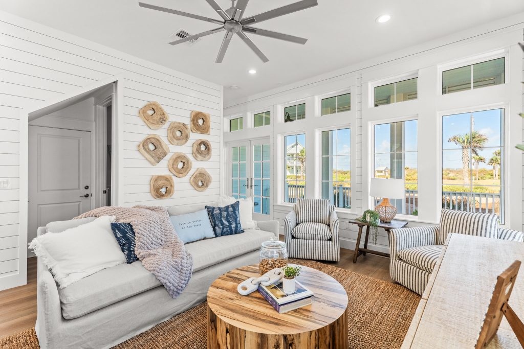 Living room with a white sofa and wall of windows at 101 Sea Whip Lane
