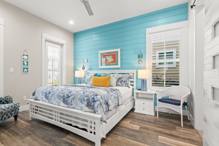 Bedroom with an aqua shiplap accent wall at 152 Sea Rocket Lane