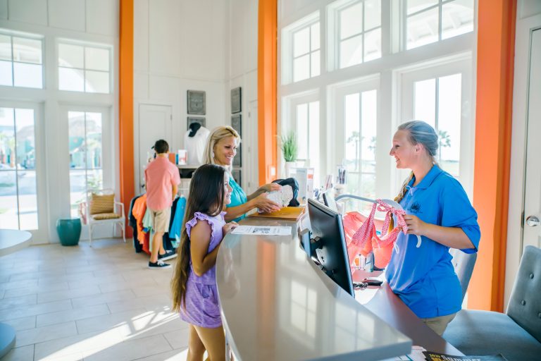 A child paying at the counter of the Palmilla Beach gift store and market