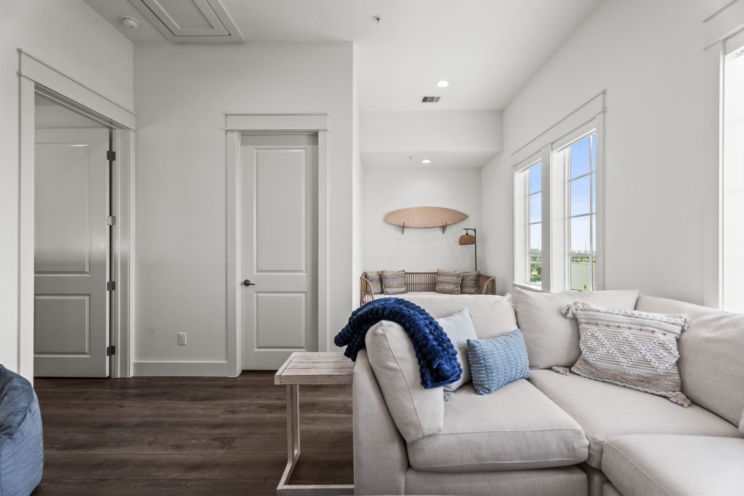 Media room with a white sectional sofa at 250 Sunrise Avenue