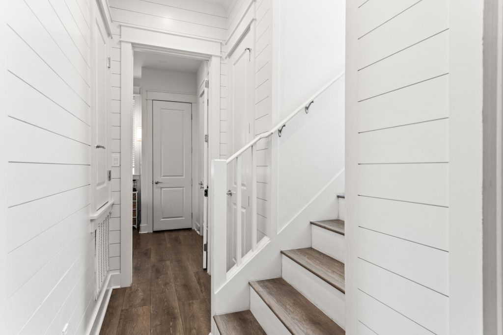 Hallway and staircase with shiplap walls at 214 Sunset Avenue #4