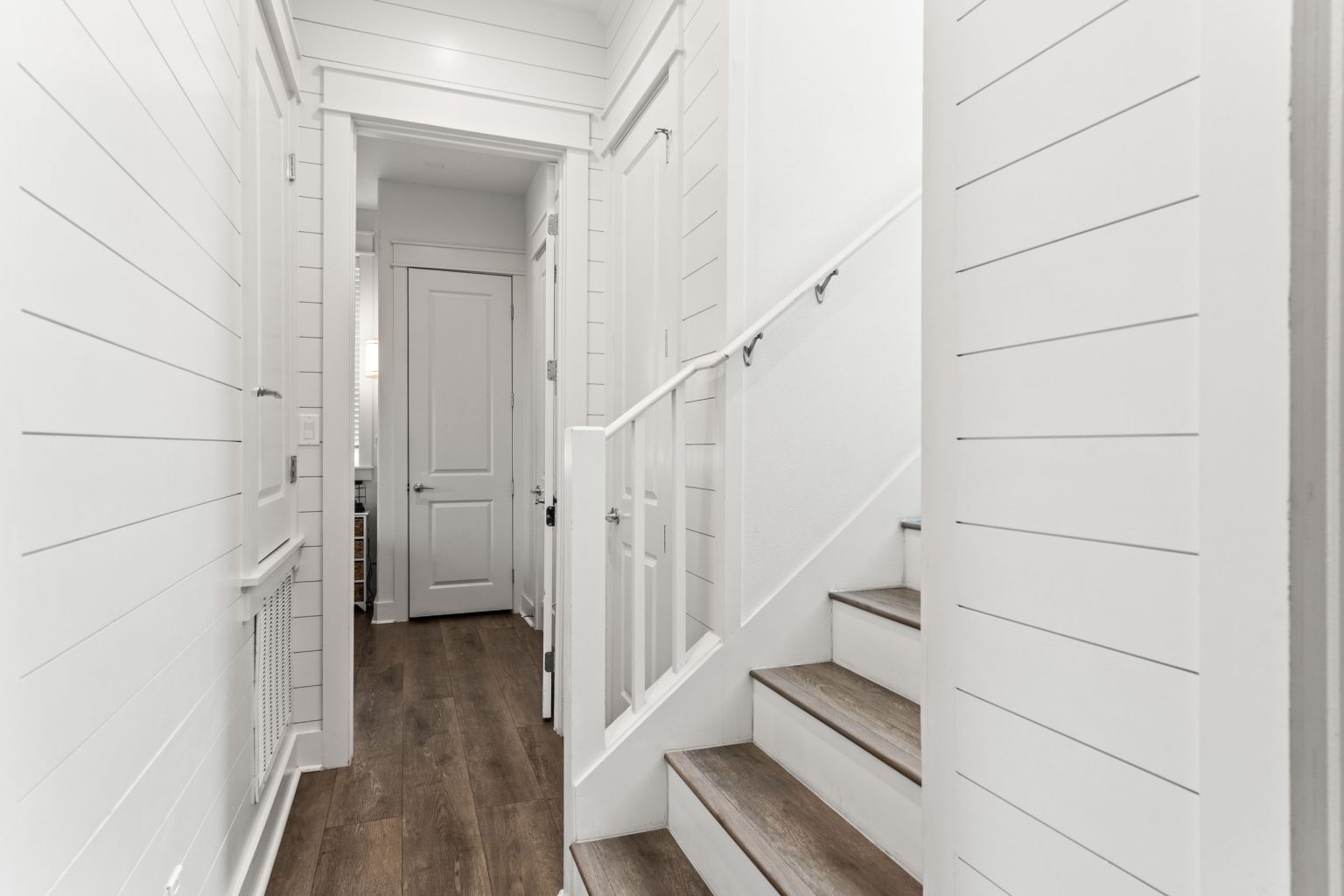 Hallway and staircase with shiplap walls at 214 Sunset Avenue #5