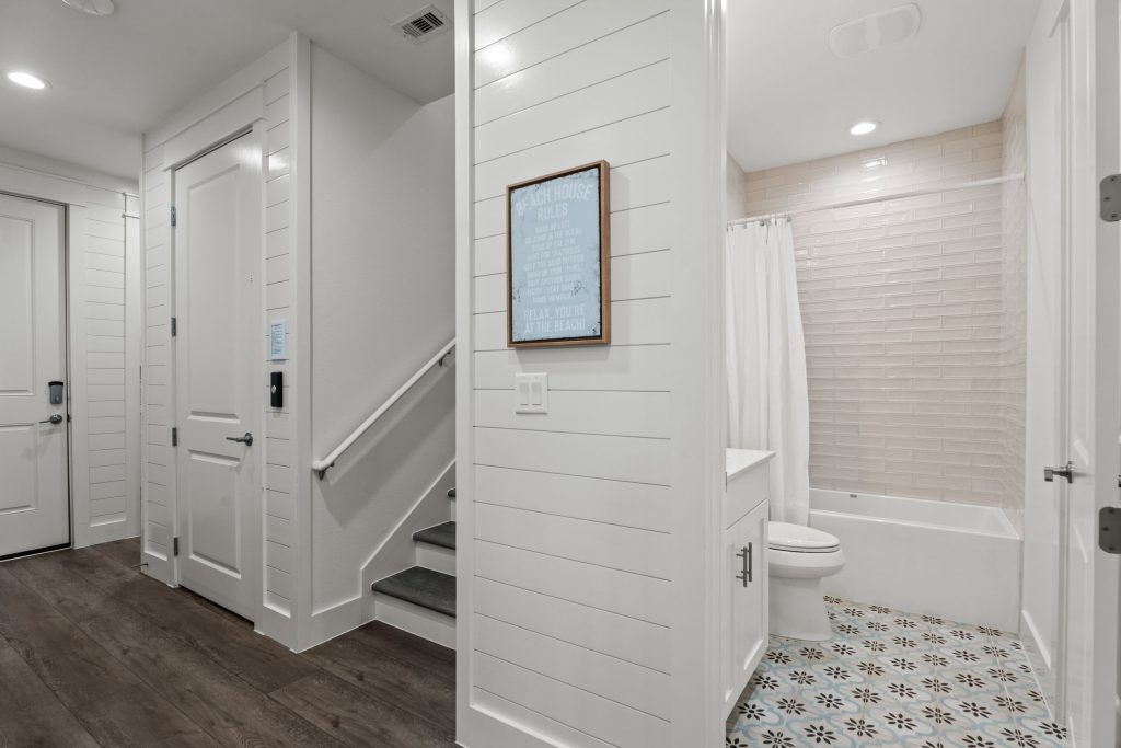 Hallway with staircase and a bathroom at 250 Sunrise Avenue
