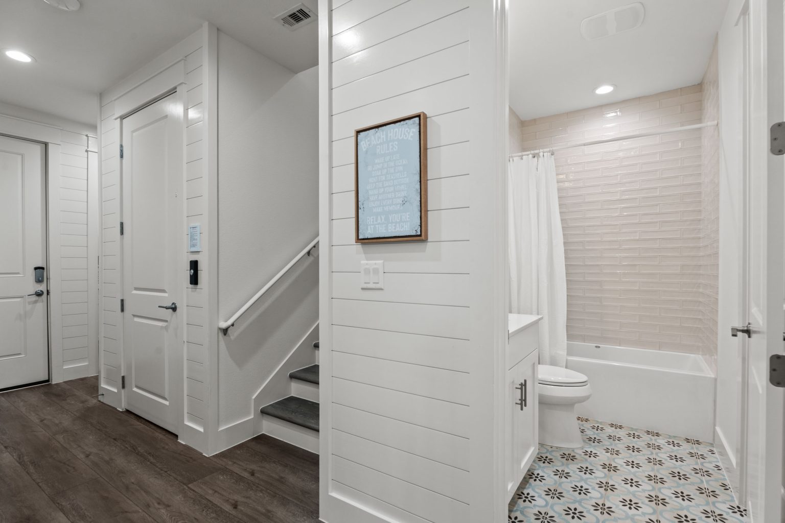 Hallway with staircase and a bathroom at 250 Sunrise Avenue