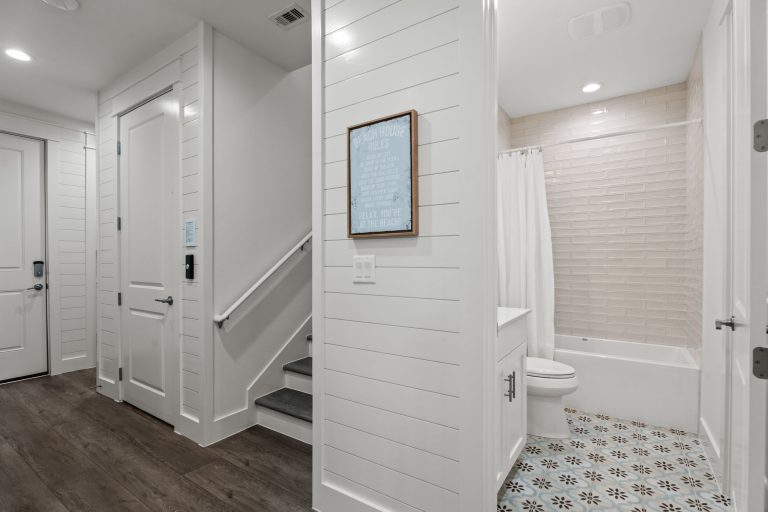 Hallway with staircase and a bathroom at 250 Sunrise Avenue