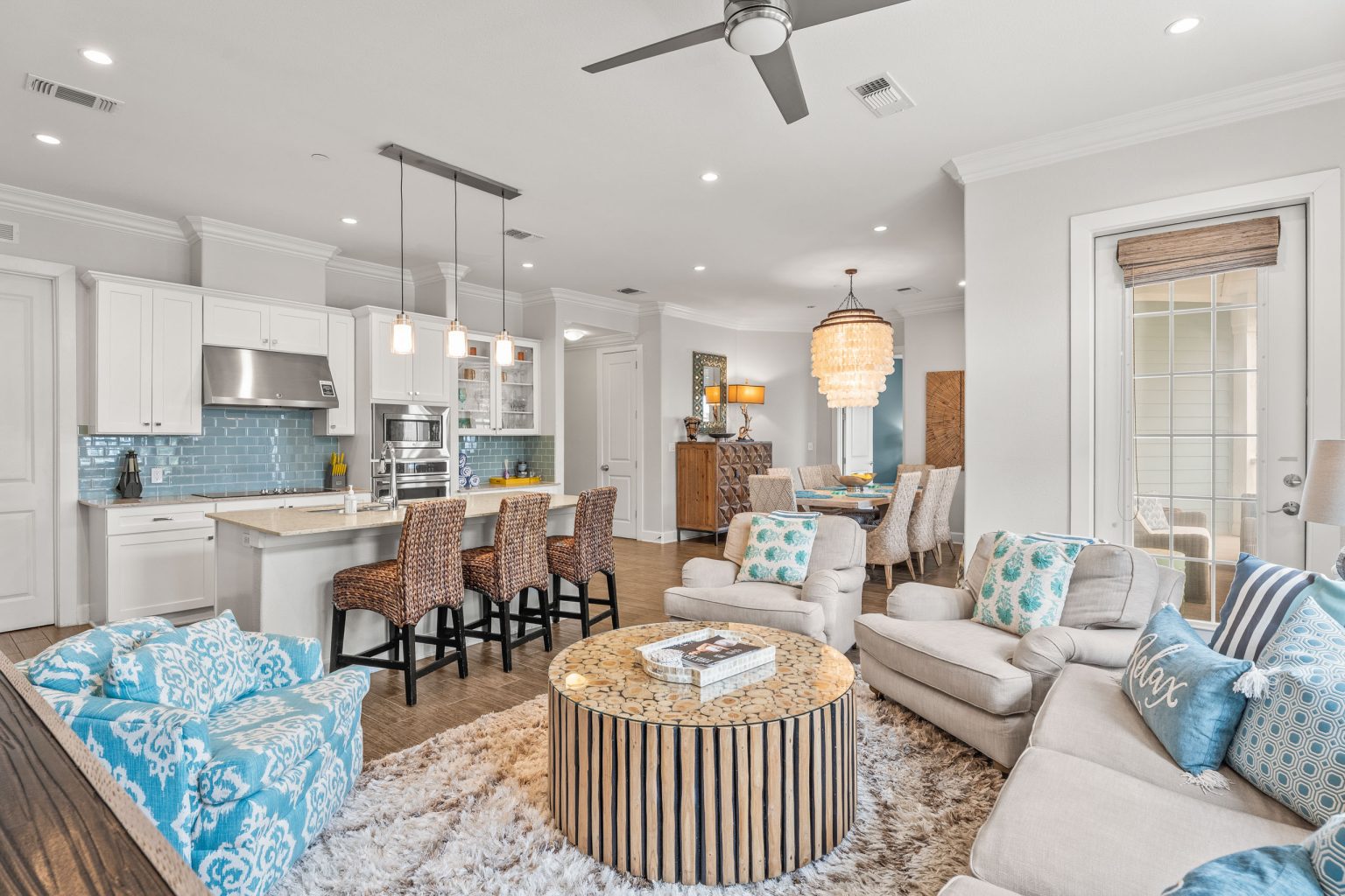 Living room with turquoise accents open to the kitchen at 137 Palmilla Circle #204