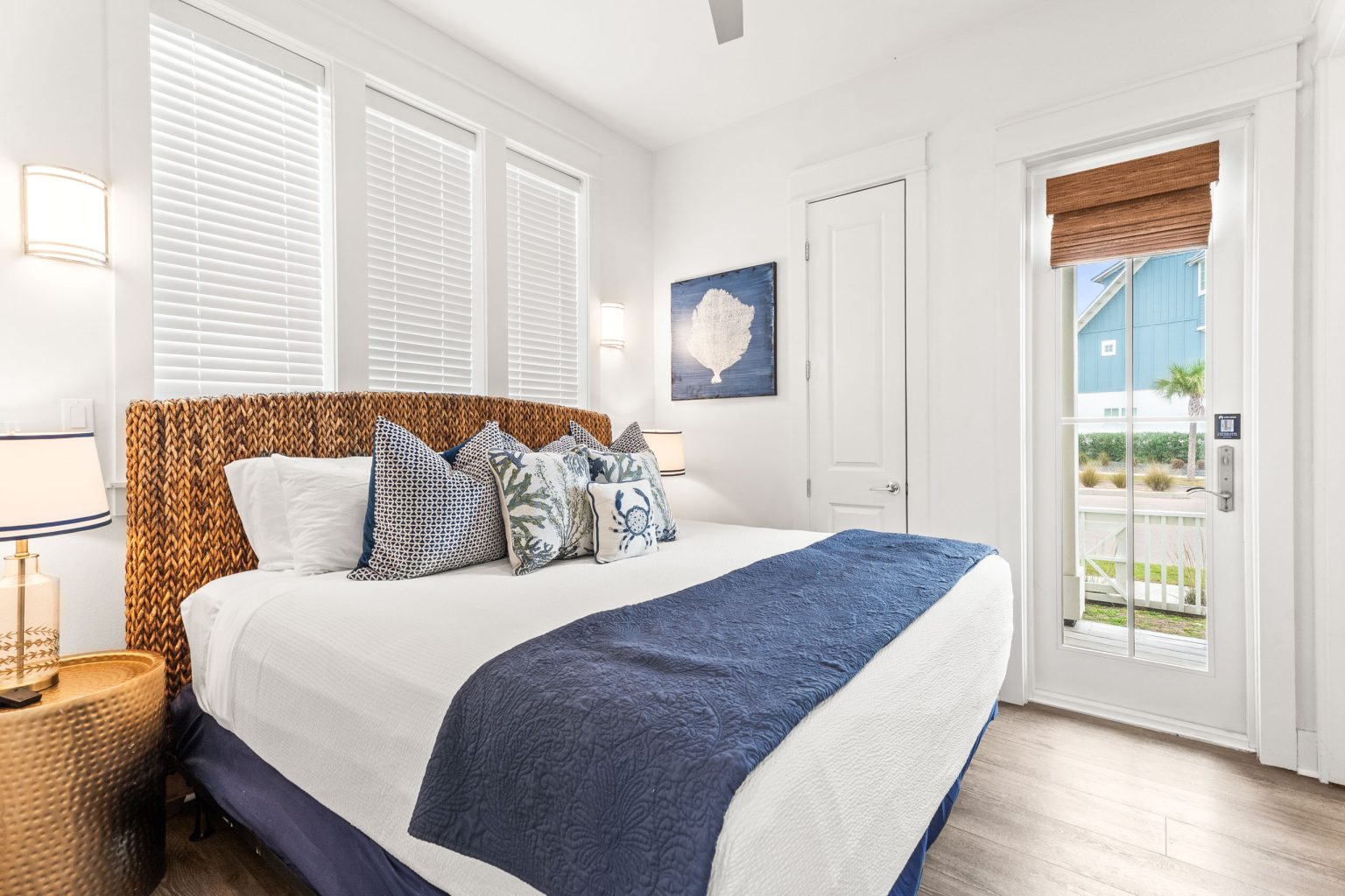 Bedroom with a woven headboard and navy throw at 214 Sunset Avenue #5