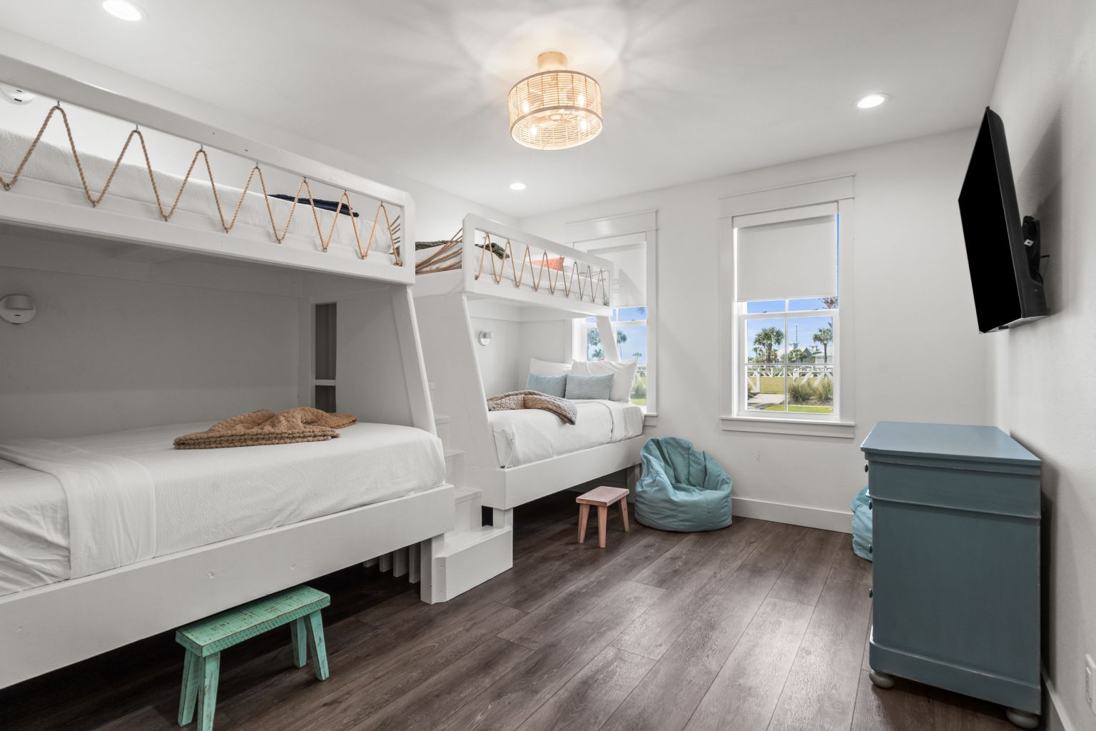 Bunk room with built-in bunk beds and a blue dresser at 250 Sunrise Avenue