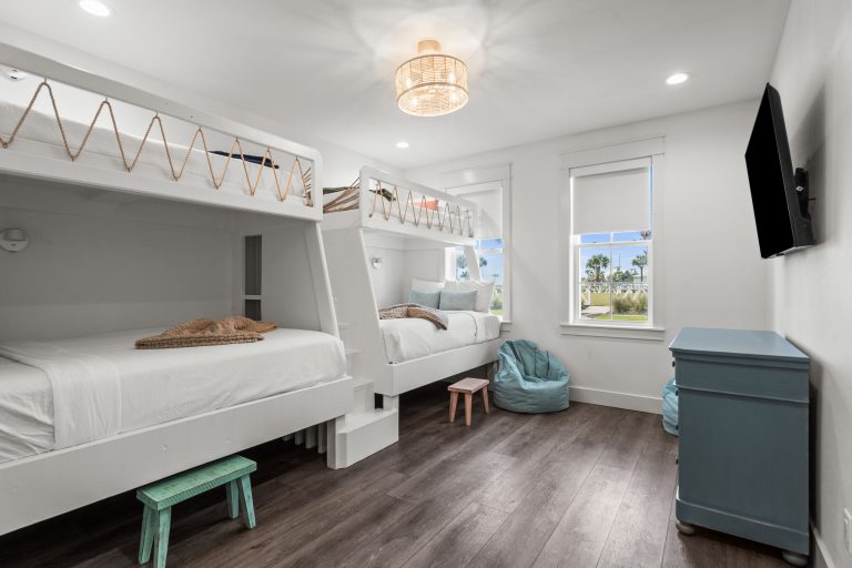 Bunk room with built-in bunk beds and a blue dresser at 250 Sunrise Avenue