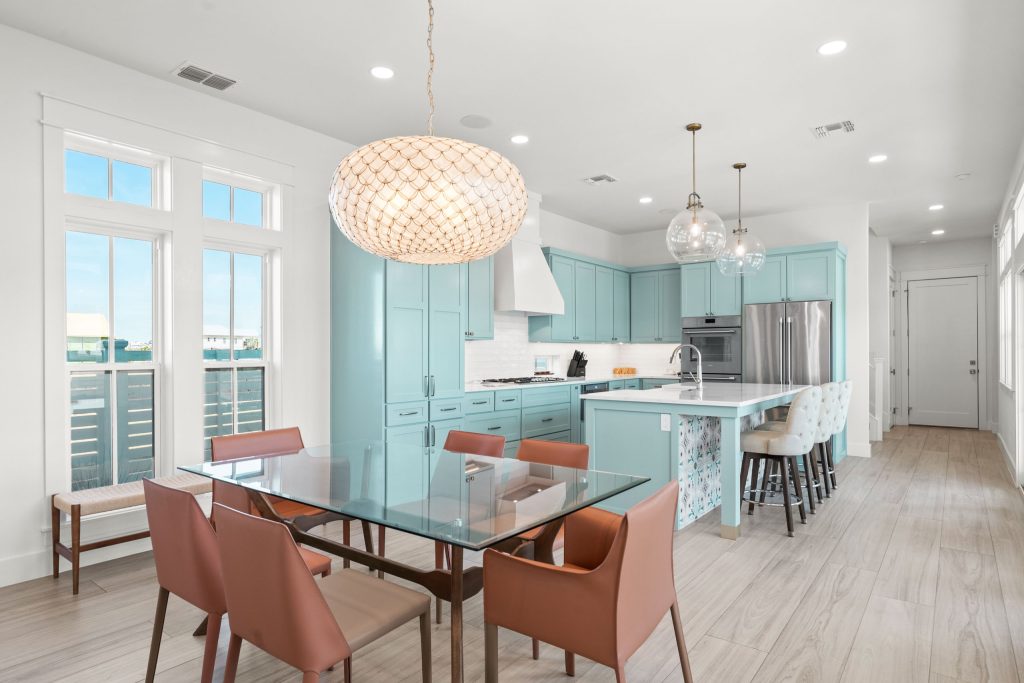 Dining area with a glass table, open to an aqua kitchen at 724 Sunset Avenue