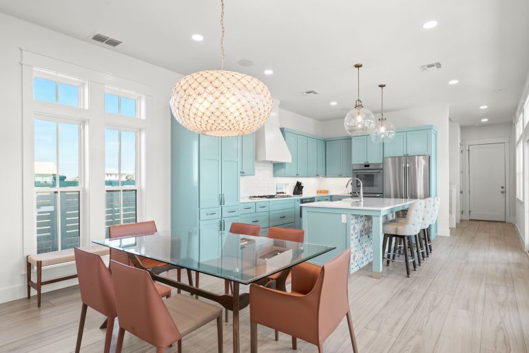 Dining area with a glass table, open to an aqua kitchen at 724 Sunset Avenue