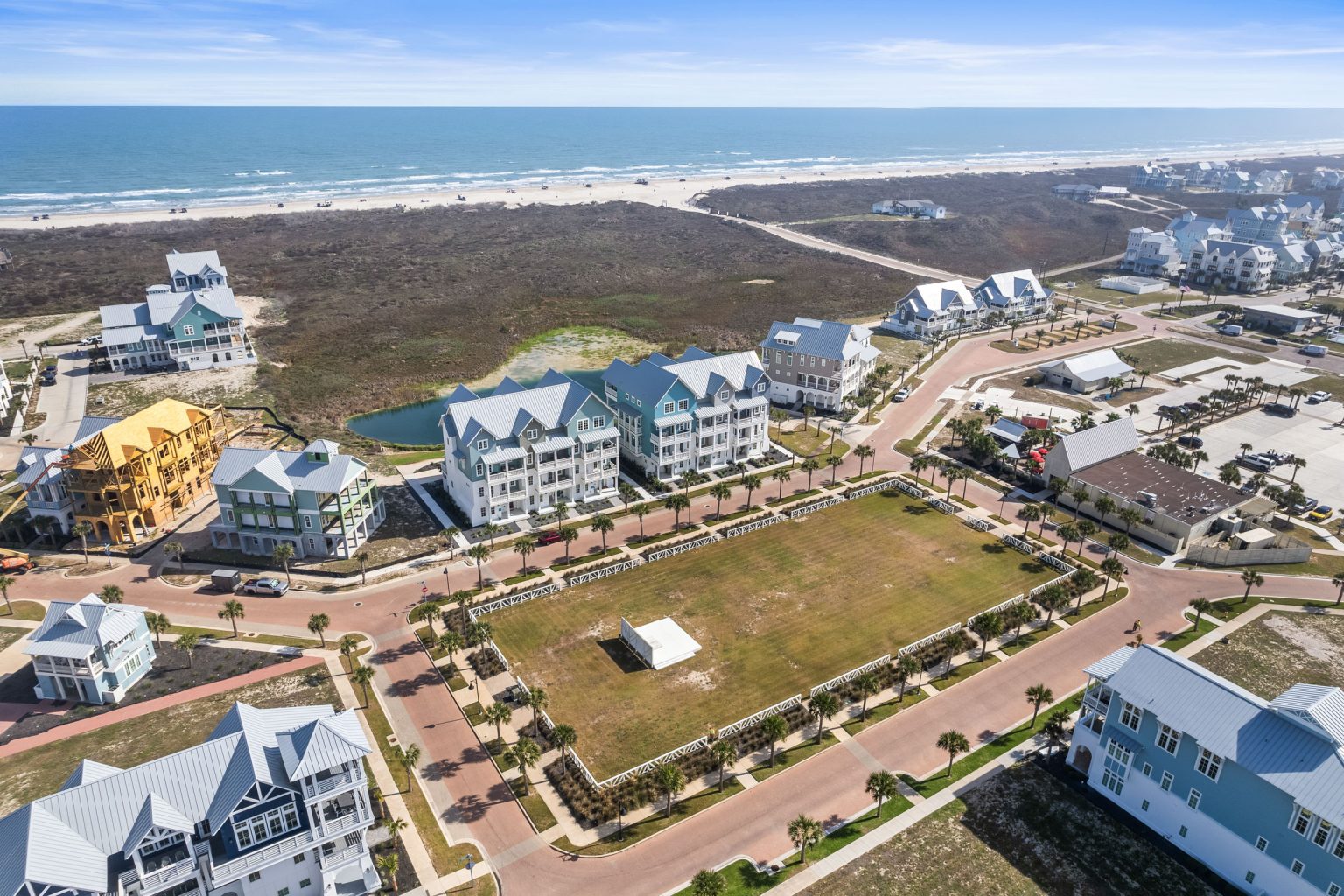 Aerial view of the 250 Sunrise Avenue townhomes facing a park and the Gulf