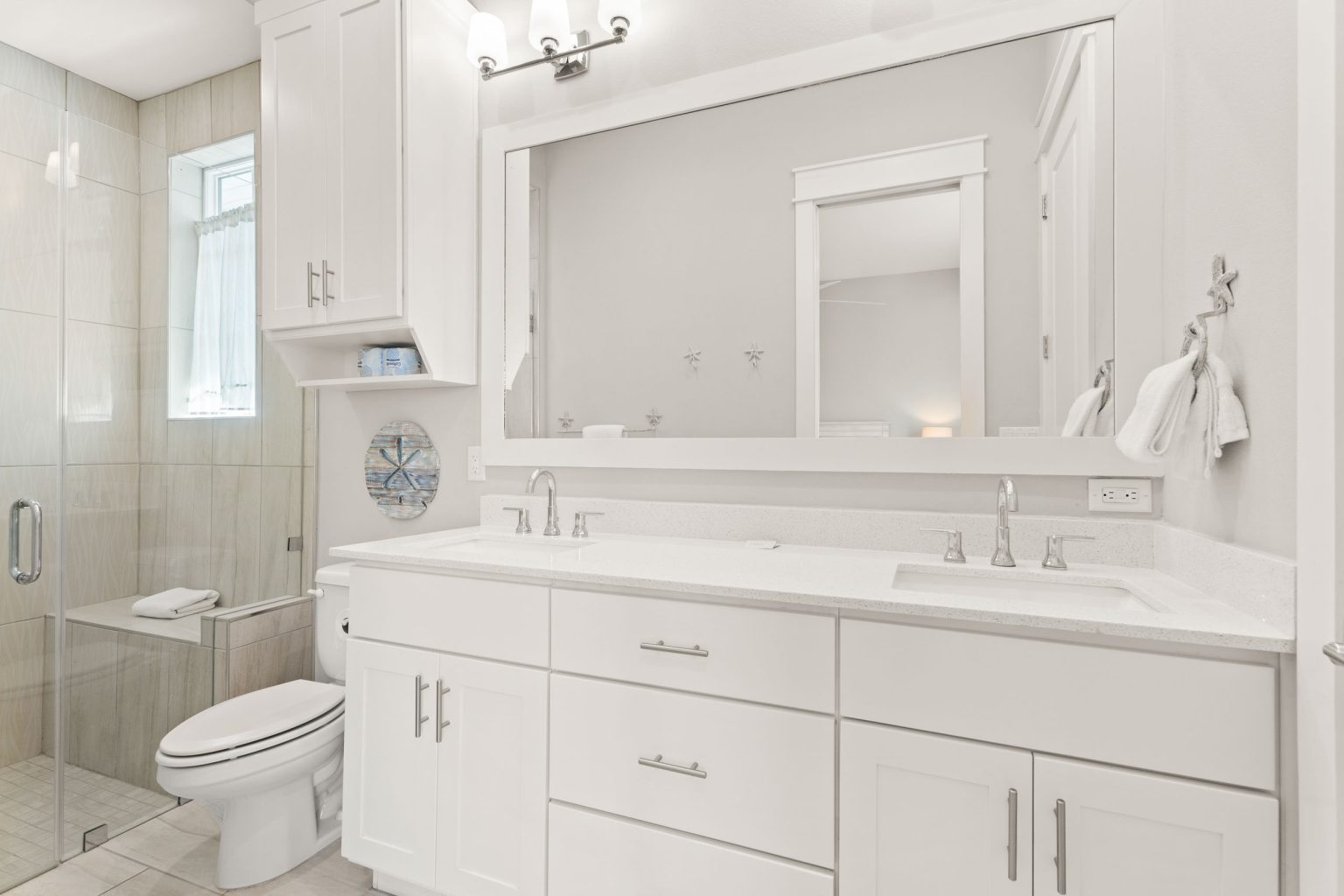 Bathroom with a double vanity and glass walk-in shower at 200 Sunset Avenue