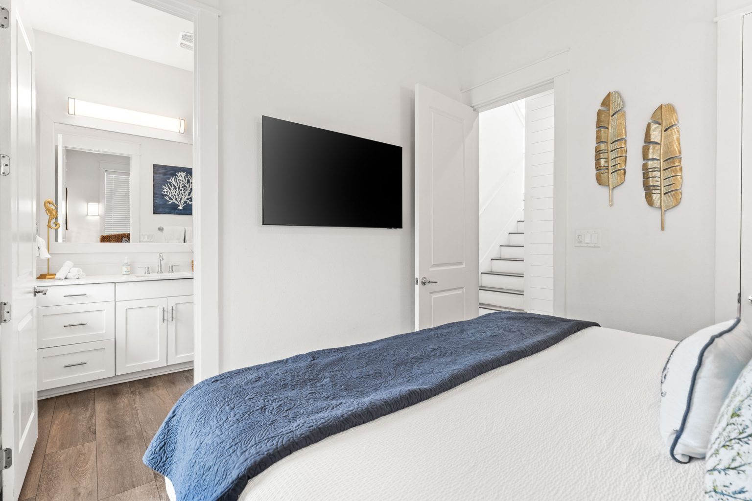 Bedroom with a wall-mounted TV and en suite bath at 214 Sunset Avenue #5