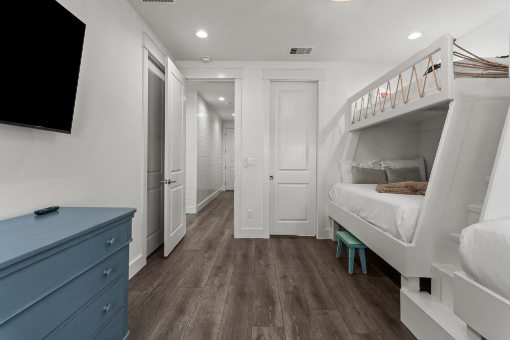 Bunk room with built-in bunks and wall-mounted TV at 250 Sunrise Avenue