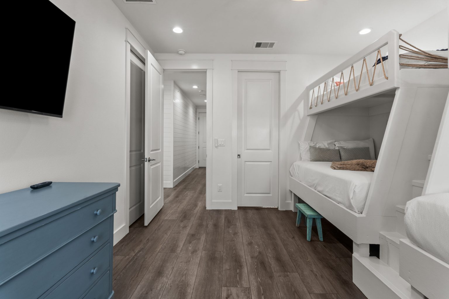 Bunk room with built-in bunks and wall-mounted TV at 250 Sunrise Avenue