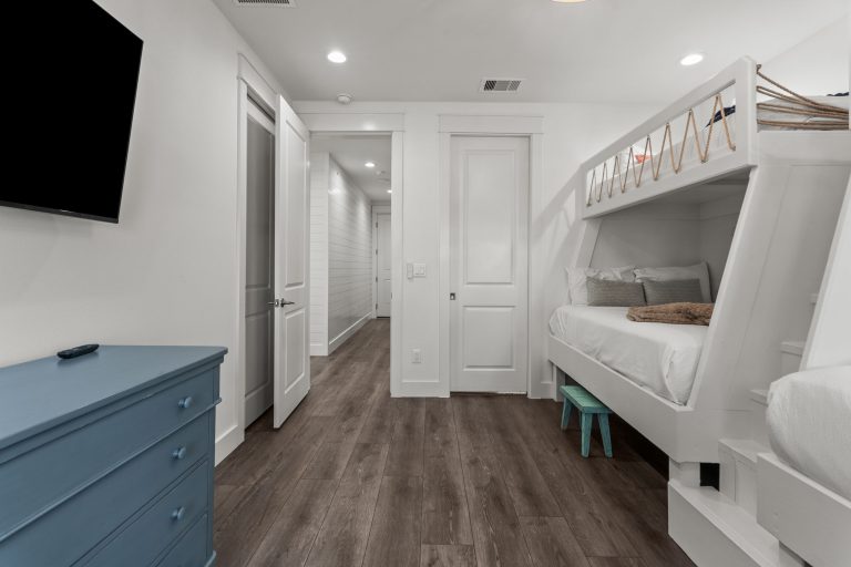 Bunk room with built-in bunks and wall-mounted TV at 250 Sunrise Avenue