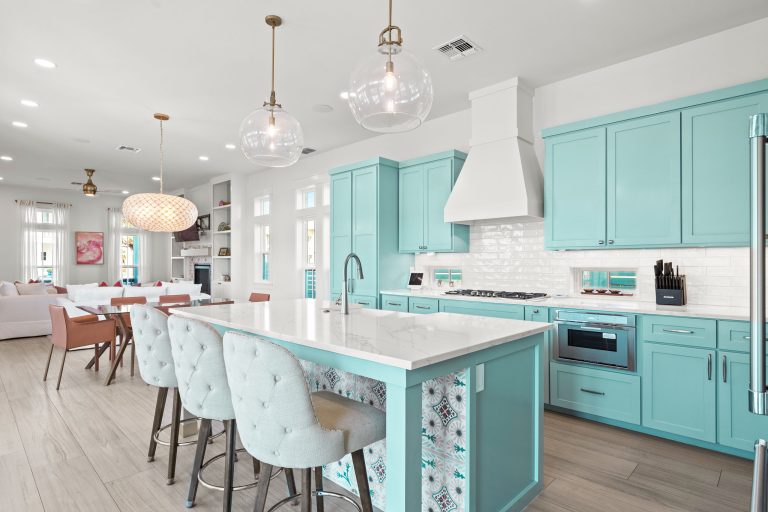 Kitchen with aqua cabinets, a large island and tufted barstools at 724 Sunset Avenue