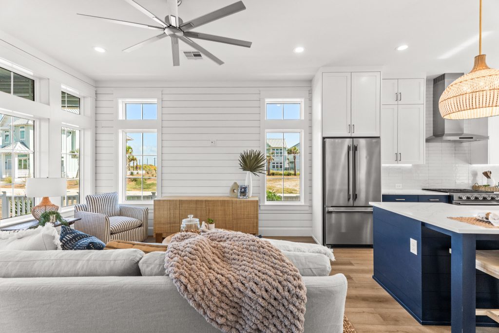 Living room open to a kitchen with a navy island at 101 Sea Whip Lane