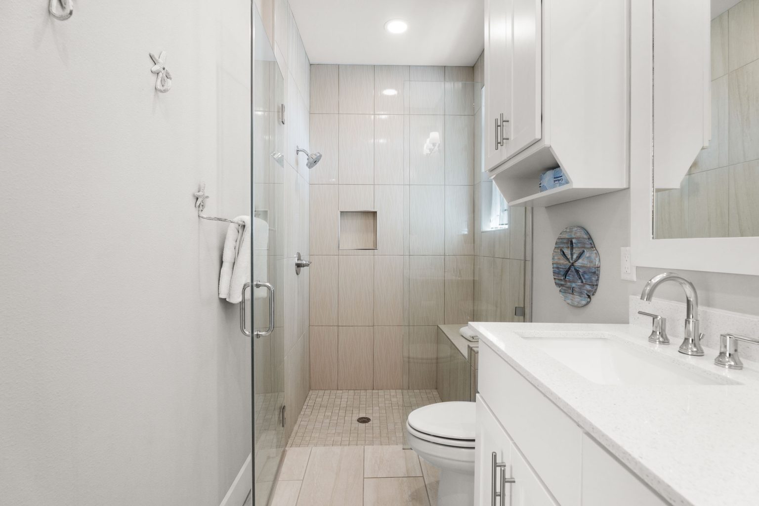 Bathroom with a walk-in glass shower and single vanity at 200 Sunset Avenue