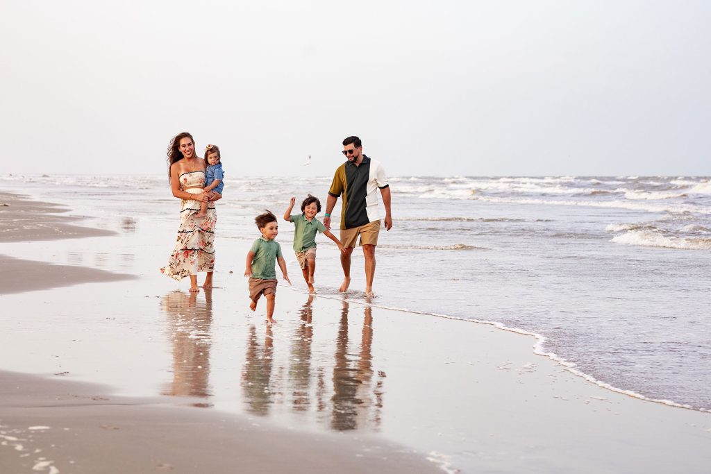 Family walking along the shoreline at Palmilla Beach