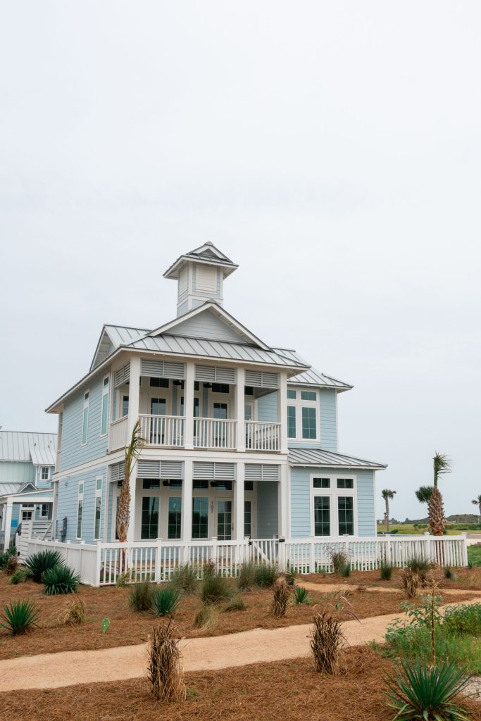 Exterior of 101 Sea Whip Lane with a cupola and double porches