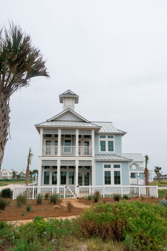 Exterior of 101 Sea Whip Lane framed by a palm tree