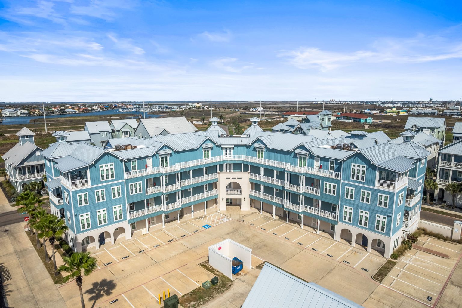 Aerial view of the blue condominium building at 137 Palmilla Circle, Palmilla Beach